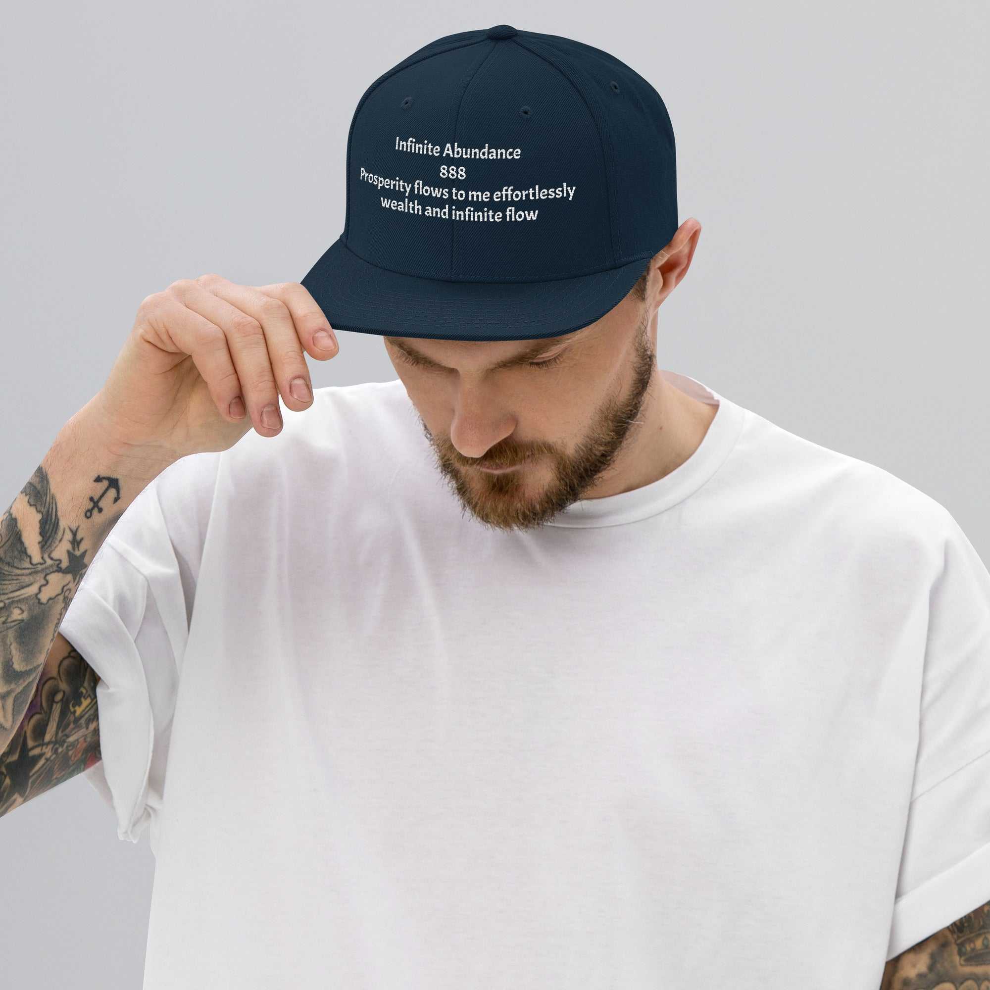 Man wearing premium structured navy blue snapback hat with embroidered motivational text and adjustable snap closure